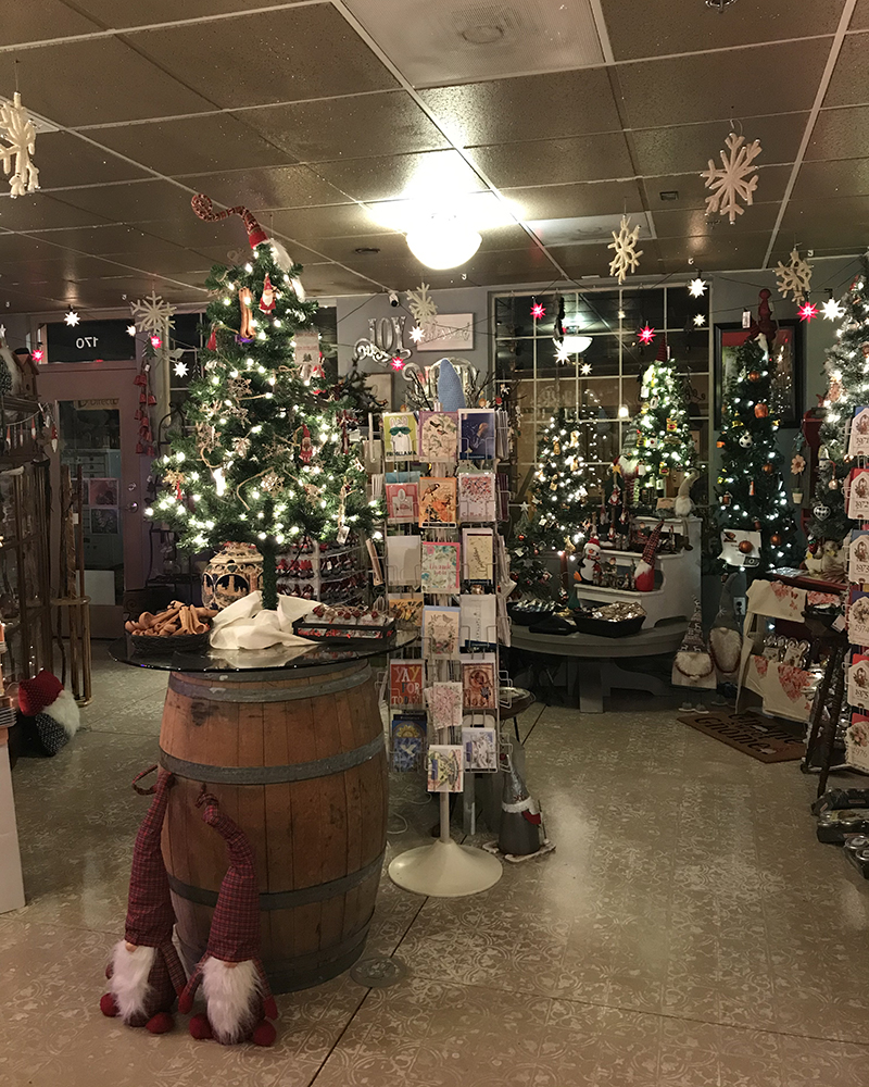 Interior of the Mount Angel Christmas store at night with the Christmas trees alight